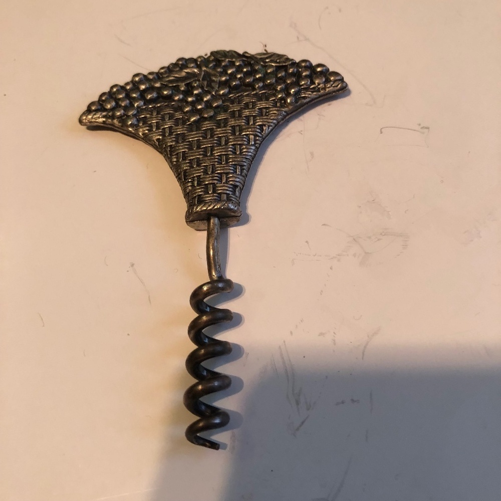 Used metal corkscrew shape of grapes- great addition for man or lady cave